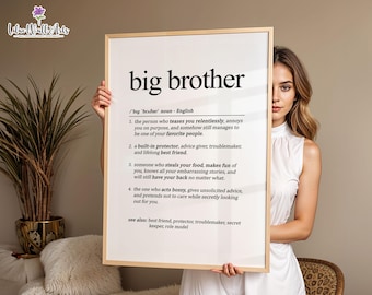 May include: A rectangular wall art print in a light wood frame featuring the dictionary definition of the term big brother. The text is printed in black on a white background, listing four numbered definitions and a see also section.