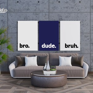 May include: Three white canvas prints with black text on a gray concrete wall. The text on the prints reads "bro." "dude." and "bruh."
