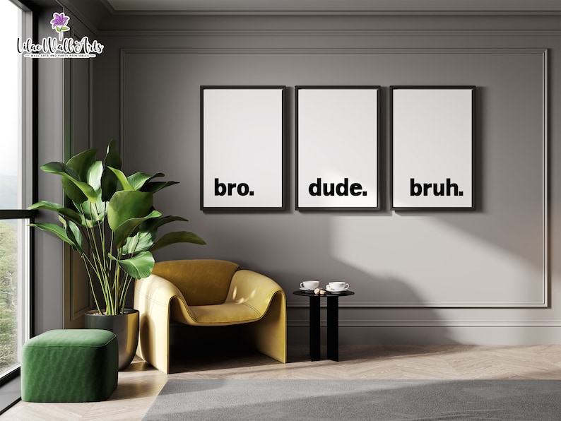 May include: Three black framed prints with white backgrounds and the words "bro." "dude." and "bruh." hanging on a gray wall in a modern living room. A yellow armchair and a green ottoman are in the foreground.