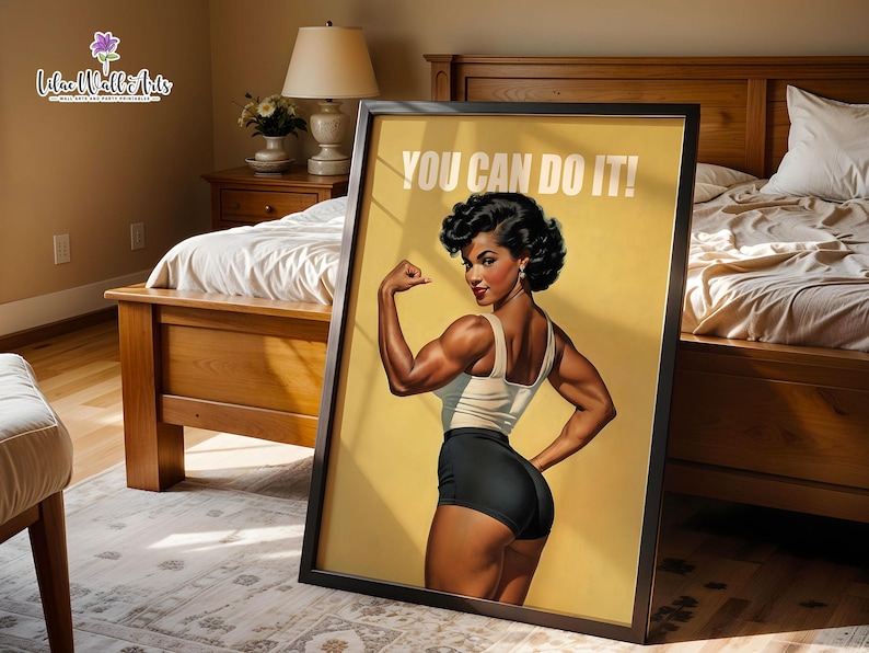 May include: A framed wall art print featuring a muscular person with dark hair in a retro style, wearing a white tank top and black shorts. The person is flexing their arm, and the text YOU CAN DO IT! is printed in white at the top of the yellow background.