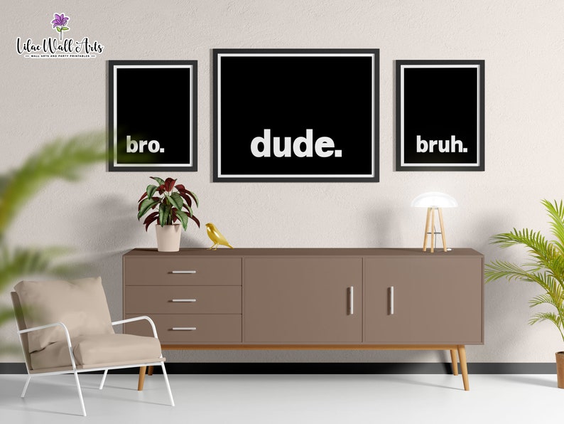 May include: Three black framed prints with white text on a white wall. The prints read "bro." "dude." and "bruh."
