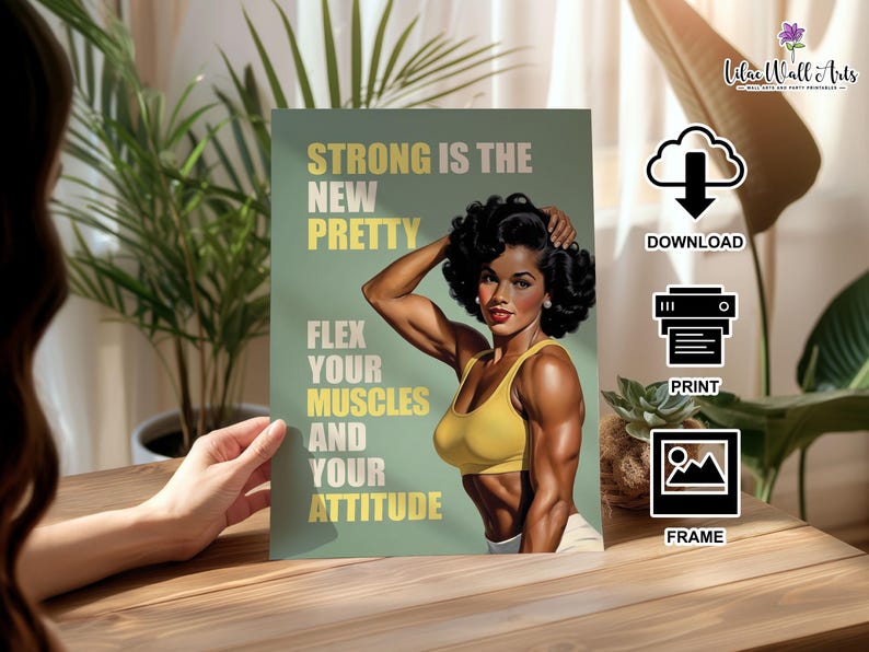 May include: A rectangular wall art print featuring a person with dark curly hair wearing a yellow sports bra, flexing their arm muscles. The background is sage green with the text: STRONG IS THE NEW PRETTY, FLEX YOUR MUSCLES AND YOUR ATTITUDE.