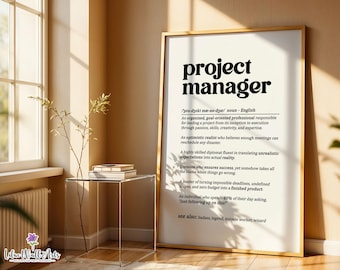 May include: A framed wall art print featuring a dictionary-style definition of the term project manager in black text on a white background. The text includes phonetic pronunciation, a noun classification, and several humorous descriptive sentences.