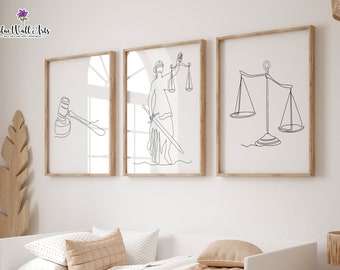 May include: Three framed art prints with line drawings of legal symbols. The prints depict a gavel, Lady Justice with a sword and scales, and scales. The frames are light brown, and the background is white.
