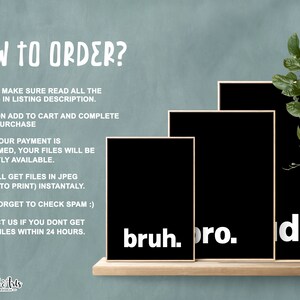 May include: Three black framed prints with white text on a wooden shelf. The text on the prints reads "bruh", "pro", and "de".