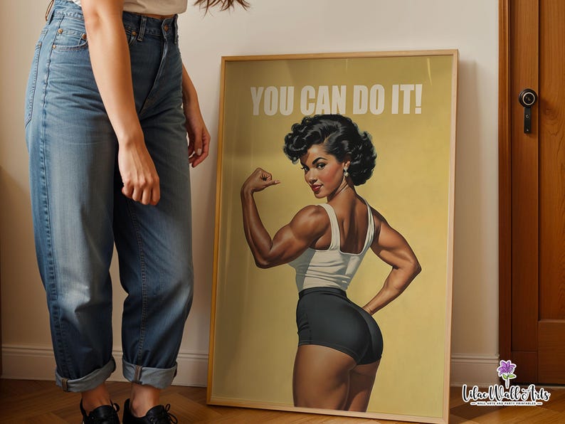 May include: A framed poster featuring a vintage-style illustration of a muscular person flexing their arm, wearing a white tank top and black shorts. The text YOU CAN DO IT! is printed in white at the top against a muted yellow background.