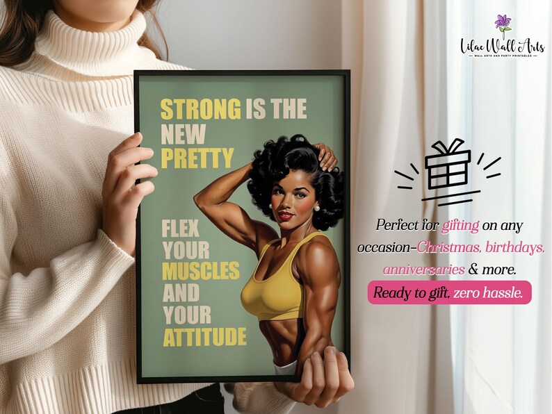 May include: A framed wall art print featuring a muscular person with dark curly hair wearing a yellow sports bra. The text reads: STRONG IS THE NEW PRETTY, FLEX YOUR MUSCLES AND YOUR ATTITUDE. The background is a muted olive green with a black frame.