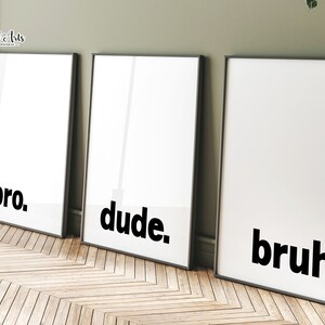 May include: Three black and white framed prints with the words "bro", "dude", and "bruh" in bold, black font.