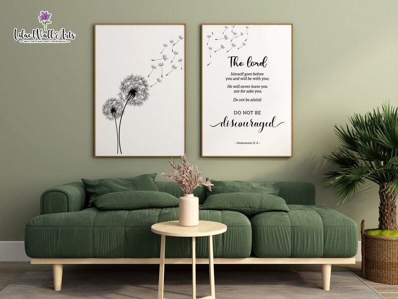 May include: Two framed prints, one with a black and white illustration of two dandelions with seeds blowing in the wind, and the other with a black and white text quote: "The Lord himself goes before you and will be with you. He will never leave you nor forsake you. Do not be afraid. Do not be discouraged." - Deuteronomy 31:8