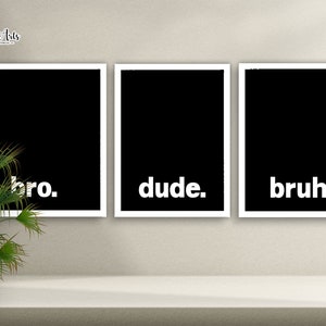 May include: Three black framed prints with white text on a beige wall. The prints read "bro." "dude." and "bruh."