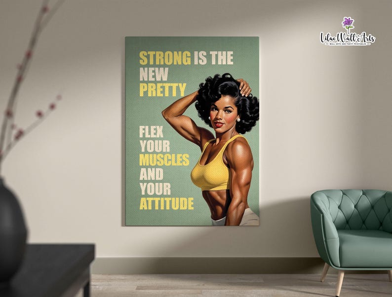 May include: A rectangular wall art print featuring a muscular individual with dark curly hair wearing a yellow sports bra. The background is sage green with the text: STRONG IS THE NEW PRETTY, FLEX YOUR MUSCLES AND YOUR ATTITUDE in yellow and white.