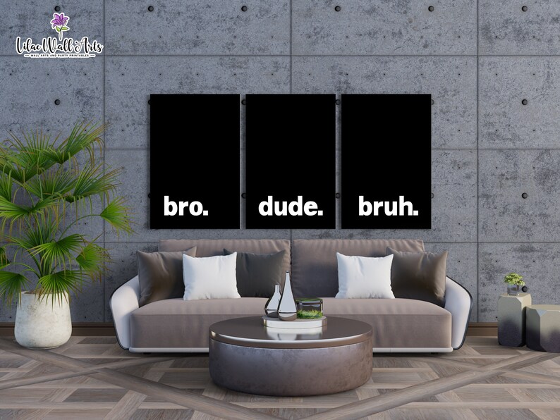 May include: Three black and white canvas prints with the words "bro." "dude." and "bruh." hanging on a gray concrete wall above a brown couch.