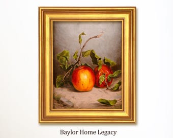 May include: A framed painting featuring two ripe apples with green leaves and a branch. The apples are a vibrant red and orange, set against a neutral background. The frame is gold, and the text "Baylor Home Legacy" is at the bottom.