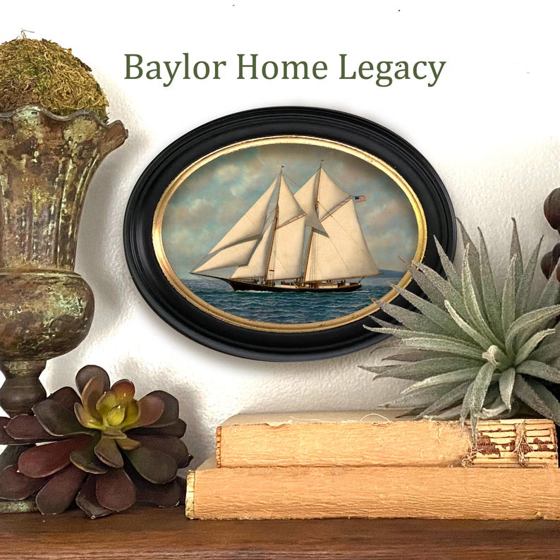 May include: A framed oval painting of a sailboat with white sails on a blue body of water. The frame is black with gold accents. The painting is titled "Baylor Home Legacy".