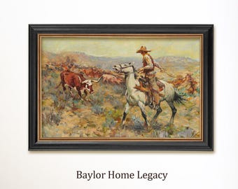 May include: A framed Western-themed painting depicts a cowboy on horseback herding cattle. The artwork features a black frame with a gold inner border. The painting has a warm color palette with a landscape background and the text "Baylor Home Legacy" at the bottom.
