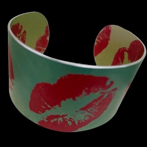 HOT LIPS COLLECTION - Vibrant And Unique Anodised Aluminium Hot Lips Cuff Bangle, red lips on faint green background
