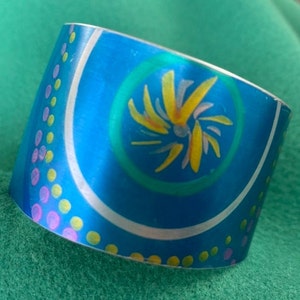 Vibrant Anodised Aluminium Tapered Cuff Bangle with Netty’s doodles, blue, yelow, green and pink