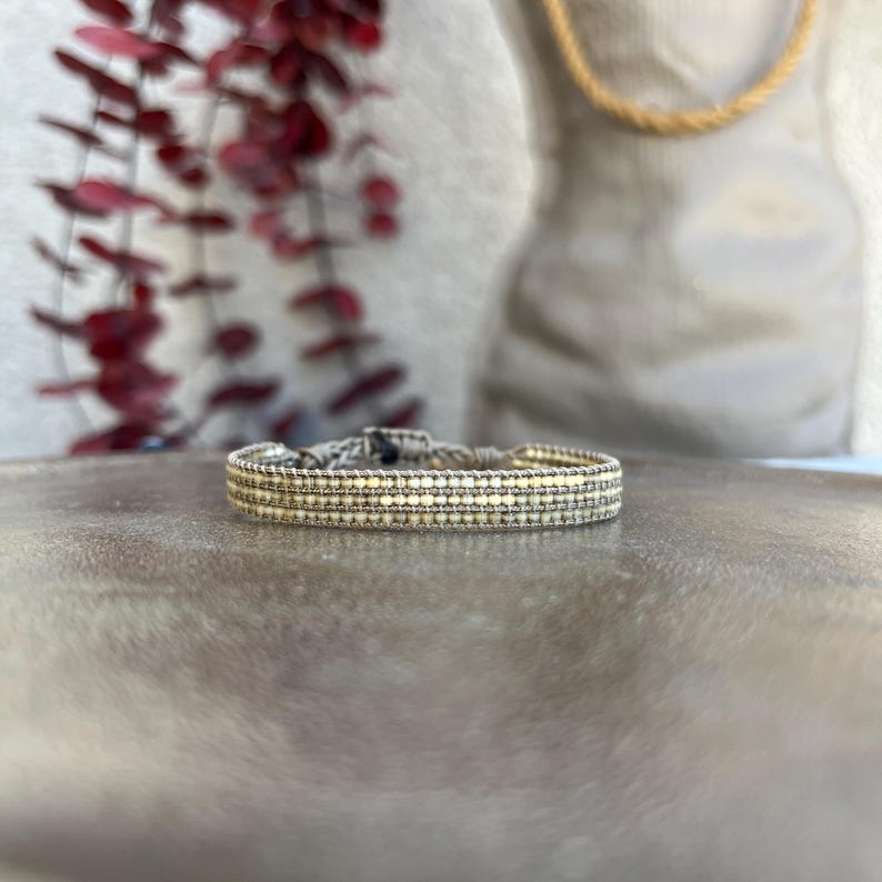 Close-up front view of the handmade thin Miyuki bracelet. Designed in a plain taupe color with a width of 1 cm.