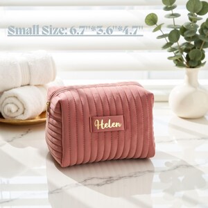 a small pink purse sitting on top of a table