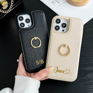 a person holding a phone case with a ring on it