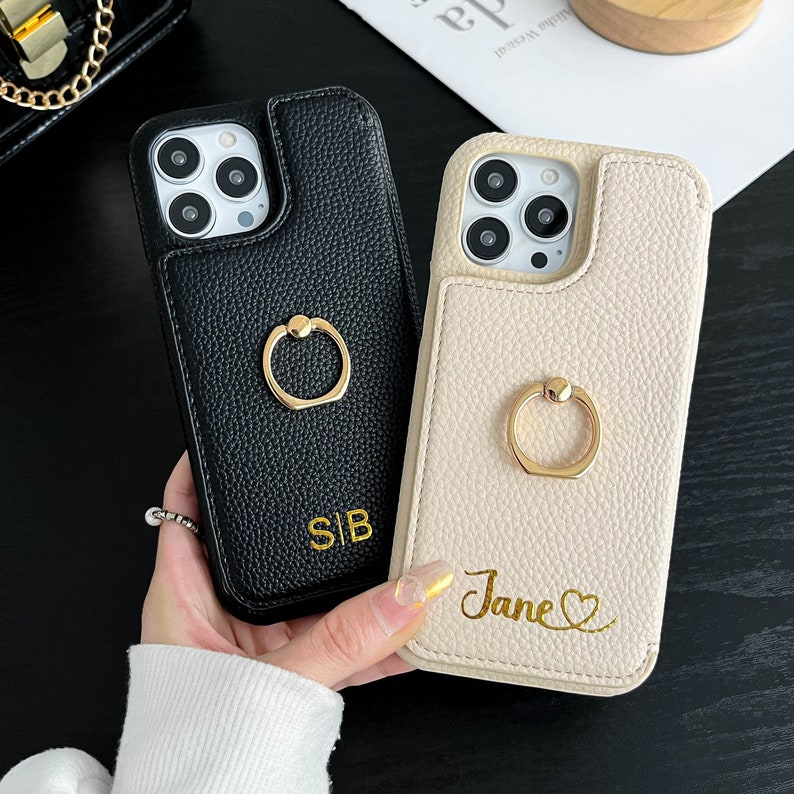 a person holding a phone case with a ring on it