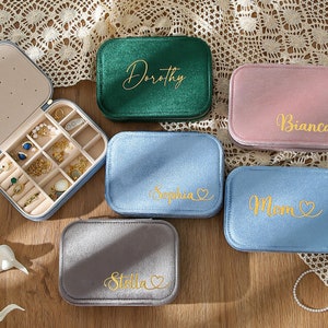 four personalized jewelry cases sitting on a table