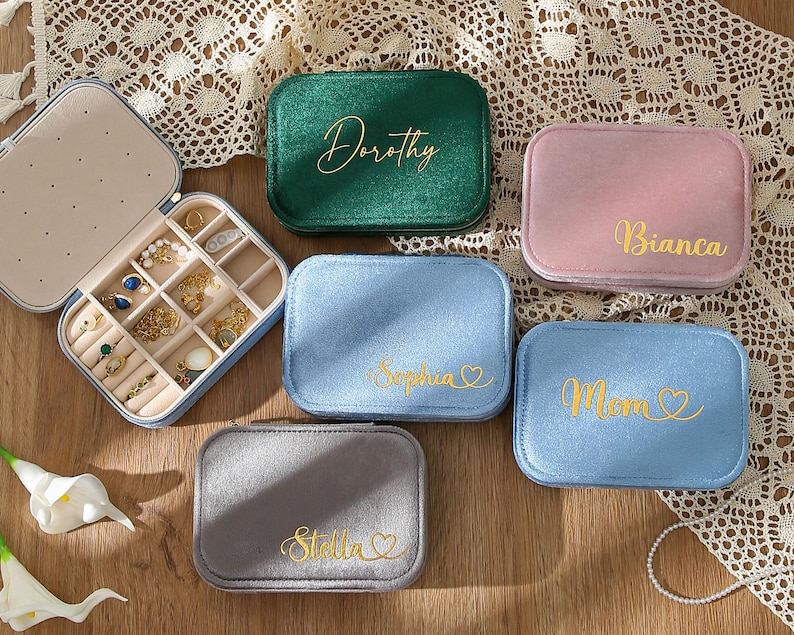 four personalized jewelry cases sitting on a table