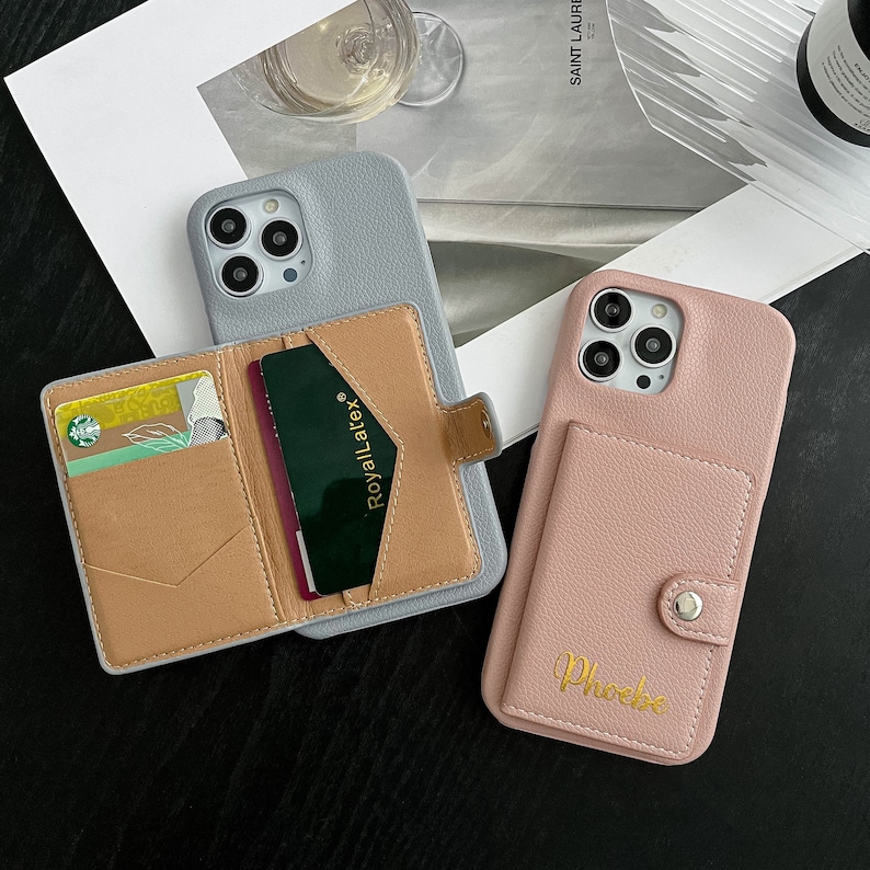 two cell phones are next to each other on a table