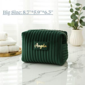 a green cosmetic bag sitting on top of a counter