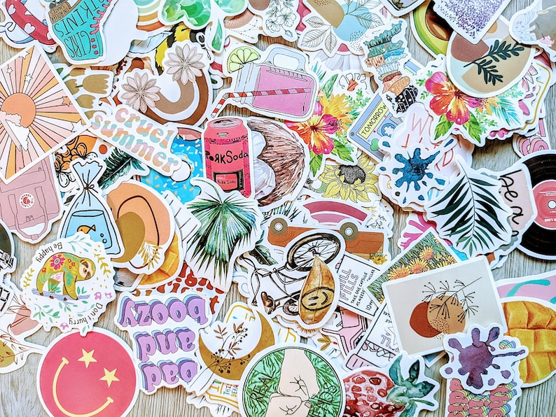 May include: A collection of colorful stickers featuring various designs, including a tropical palm tree, a bicycle, a coconut, a sloth, a sun, a soda can, a flower, and a phrase that says "cruel summer".