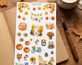 May include: A white sticker sheet featuring autumn-themed illustrations including orange pumpkins, yellow sunflowers, colorful maple leaves, a bicycle, a candle, mushrooms, pinecones, and beverages with the text "FALL" on a banner and "Fall in love".