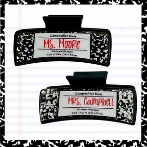 May include: Two black and white composition book hair clips. Each clip has a white label with the text "Composition Book" and a name in red. The clips are 9 3/4 x 7 1/2 inches.
