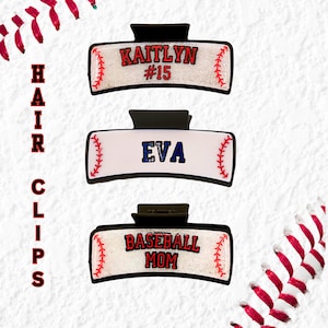 May include: Three white and black baseball-themed hair clips with glitter. The top clip says "Kaitlyn #15", the middle clip says "Eva", and the bottom clip says "Baseball Mom".