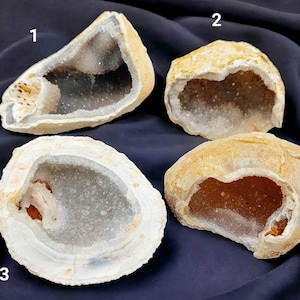 May include: Four agate geode specimens with different shapes and sizes. The geodes are open and reveal a crystal-lined interior. The geodes are numbered 1 through 4.