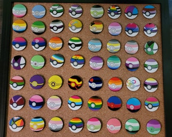 May include: A corkboard with 100 colorful round pins with various designs. The pins are arranged in a grid pattern and are all the same size. The corkboard is framed in black.