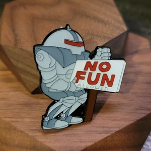 May include: A gray robot with a red visor holding a white sign that says 'NO FUN ALLOWED' in red letters.