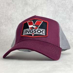 May include: Burgundy and grey trucker hat with a black and white patch featuring a handshake and the text "INGSOC".