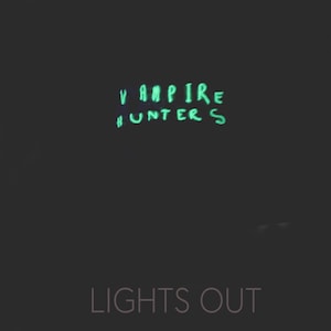 May include: A black background with the words "Vampire Hunters" written in green glow-in-the-dark paint. Below the words is the text "Lights Out" in white.