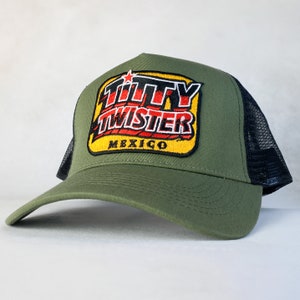 May include: A green and black trucker hat with a yellow, red, and black embroidered patch that says "Titty Twister Mexico".