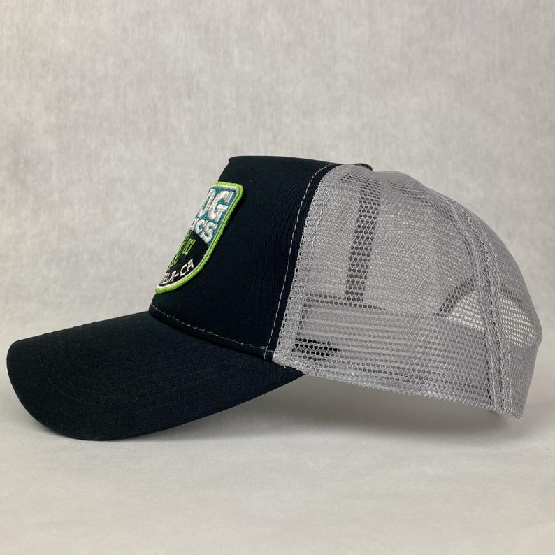 May include: A black and gray trucker hat with a green and blue embroidered patch that says "Big Sur Organics" and "Monterey, CA".