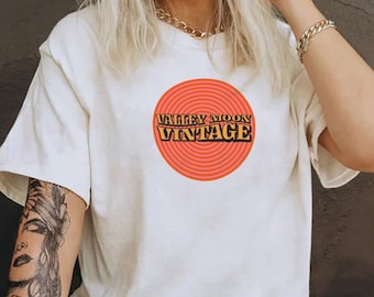 May include: A white t-shirt with a red and yellow graphic that says "Valley Moon Vintage".