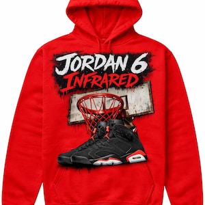 以下が含まれることがあります： バスケットボールのゴールと黒と赤のスニーカーの上に「JORDAN 6 INFRARED」の文字が入った赤いフード付きスウェットシャツ。スウェットシャツは無地の赤色です。