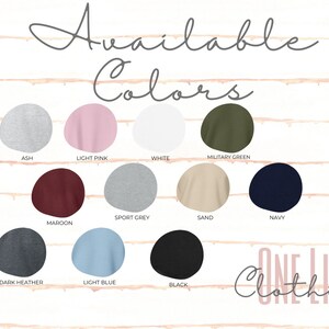 May include: A graphic showing a selection of available colors for clothing items. Colors include ash, light pink, white, military green, sport grey, sand, navy, maroon, dark heather, light blue, and black. The text "Available Colors" is at the top.