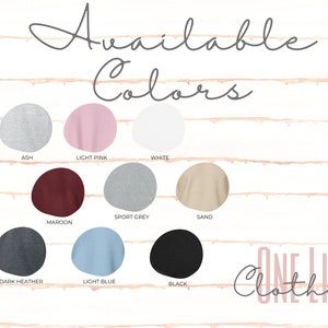 May include: A display of available sweatshirt colours: ash, light pink, white, maroon, sport grey, sand, dark heather, light blue, and black. The words "Available Colors" are at the top, with "ONE LIFE CLOTHING" at the bottom.