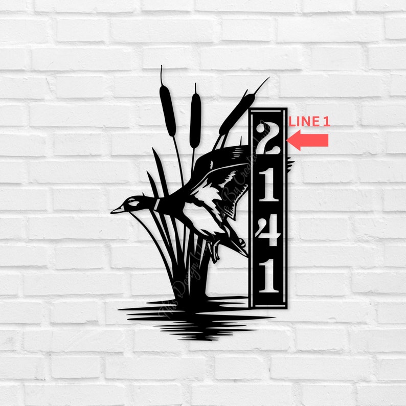 May include: Black metal wall art depicting a duck in flight above water and reeds. A vertical panel displays the numbers 2141 in white. The artwork is mounted on a white brick wall.