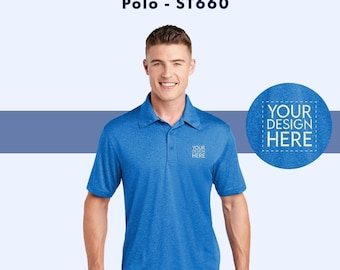 May include: A blue heather polo shirt with short sleeves and a button-down collar. The shirt has a small embroidered design on the left chest that says "YOUR DESIGN HERE".