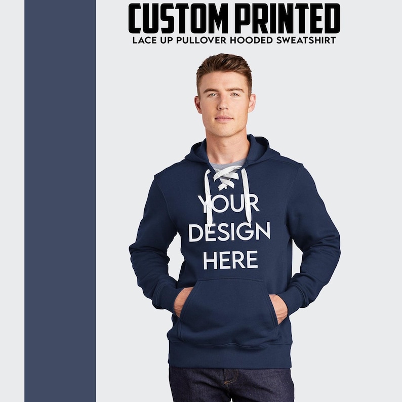Puede incluir: Sudadera con capucha azul marino con cordones blancos y el texto "YOUR DESIGN HERE" impreso en la parte delantera.