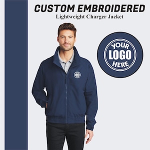 May include: A navy blue lightweight charger jacket with a zipper closure. The jacket has a mock neck and a white embroidered logo that says "YOUR LOGO HERE".