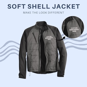 May include: A gray and black soft shell jacket with the text "SOFT SHELL JACKET" and "MAKE THE LOOK DIFFERENT". The jacket has a zip-up front, a stand-up collar, and a small pocket on the chest. The jacket has the words "CUSTOM EMBROIDERY HERE" on the chest.