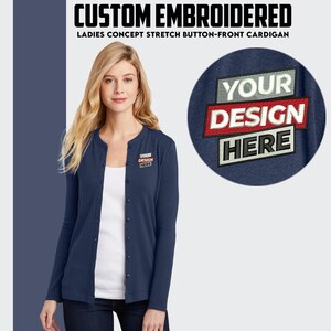 May include: A navy blue cardigan with a button front and long sleeves. The cardigan has a small embroidered patch on the left chest that says "YOUR DESIGN HERE".